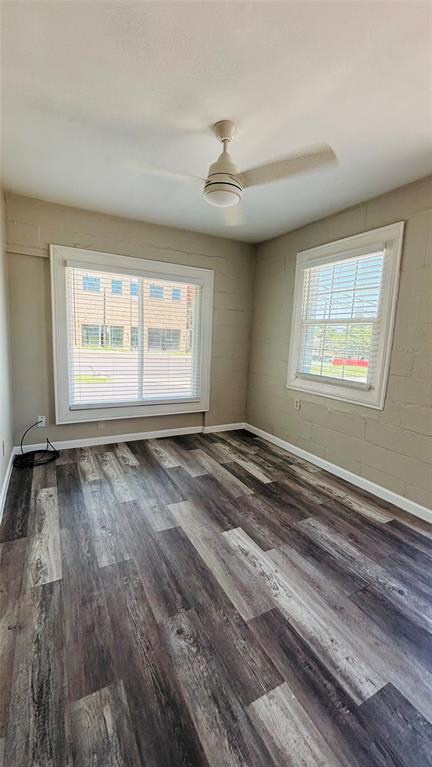 260 South Corinth St Road, Unit 260 Dallas, TX 75203 - Photo 6 of 8 a view of an empty room with wooden floor and a window