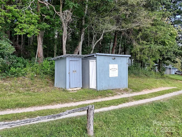 a view of house with a backyard