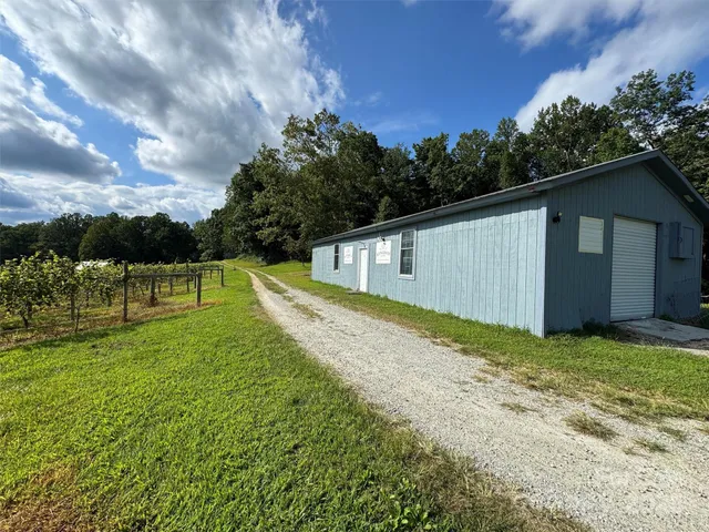 a view of a wooden house with a yard