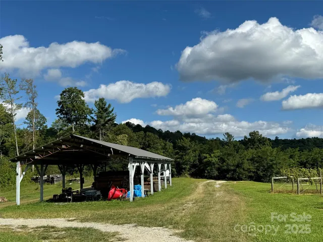 a view of a garden with a house in the background
