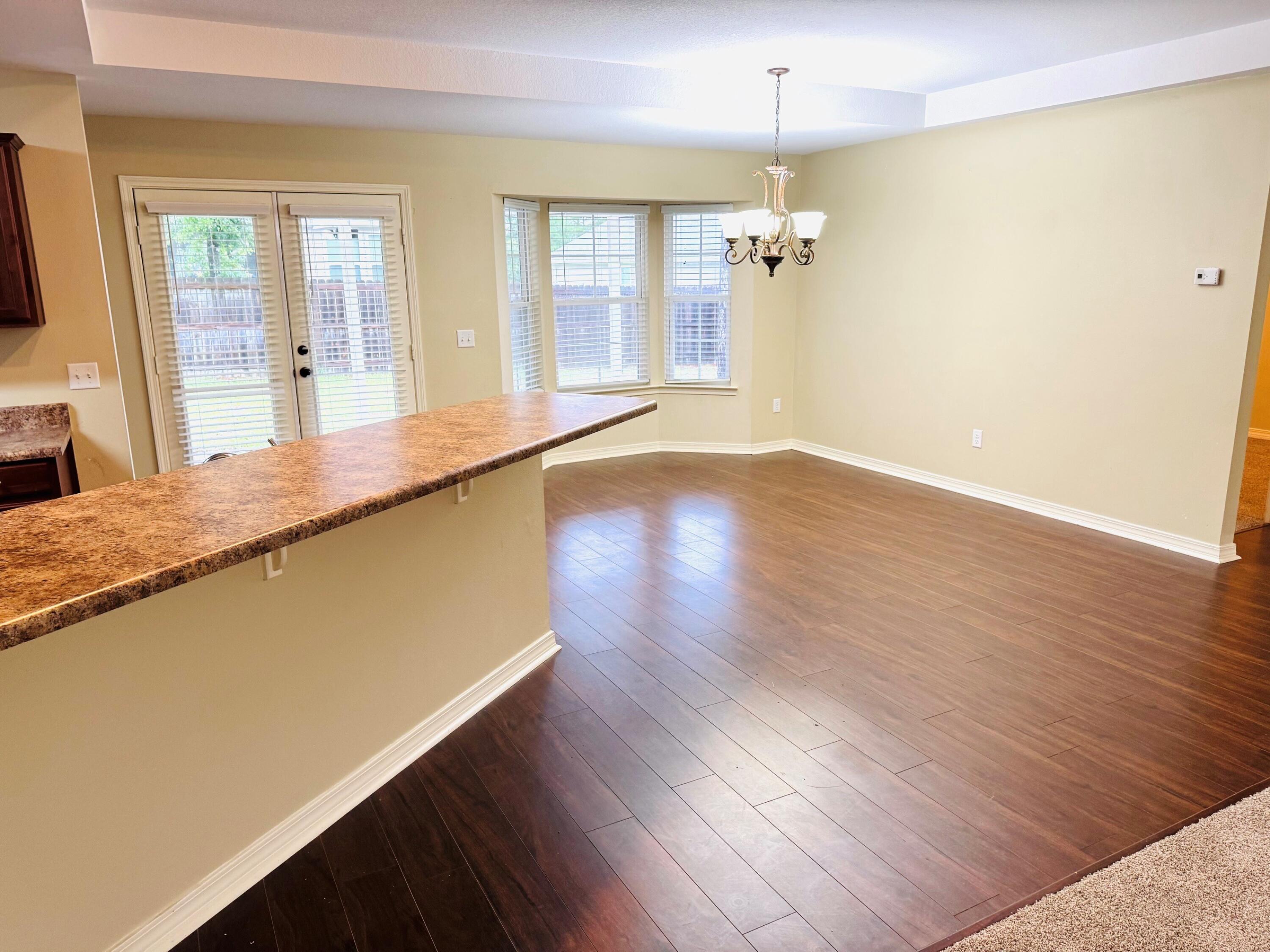 594 Hunters Ridge Road DeFuniak Springs, FL 32433 - Photo 4 of 17 a view of a living room with wooden floor and a ceiling fan