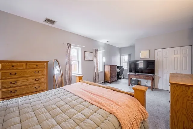 a bedroom with a bed and flat screen tv
