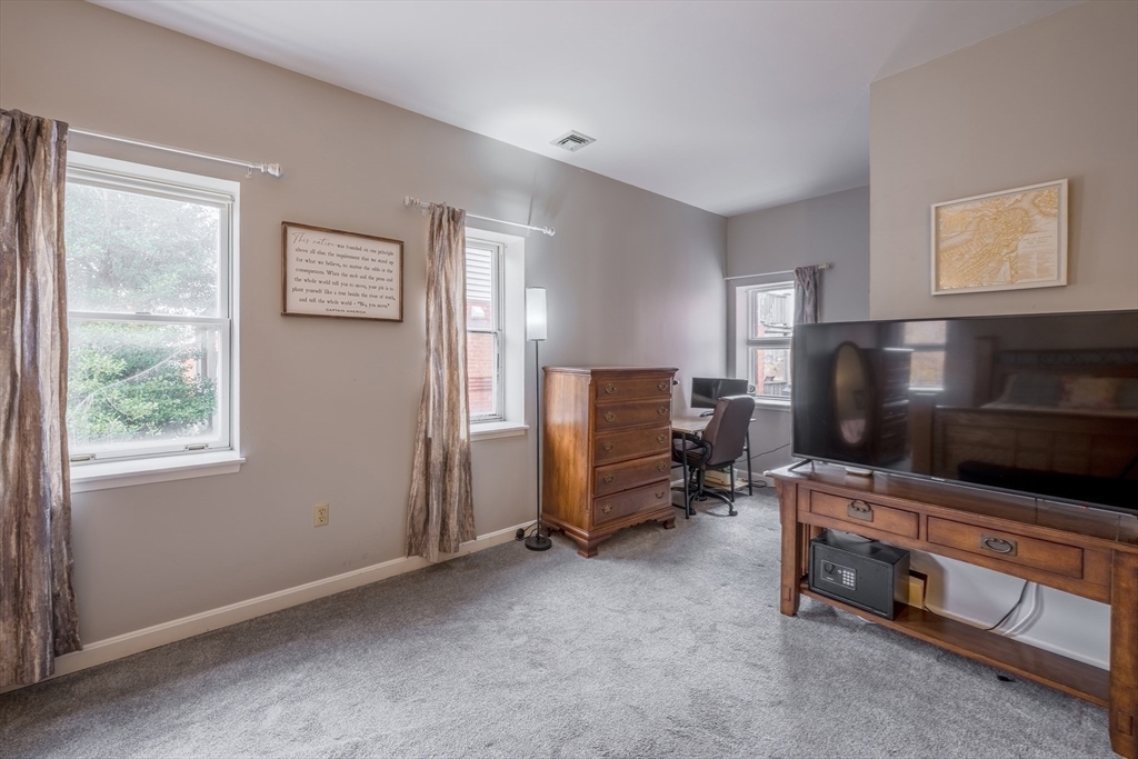 45 Main Street, Unit 38 Wareham, MA 02571 - Photo 12 of 30 a living room with furniture and a flat screen tv