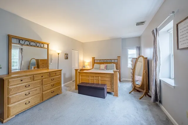 a bedroom with a bed and a dresser in it