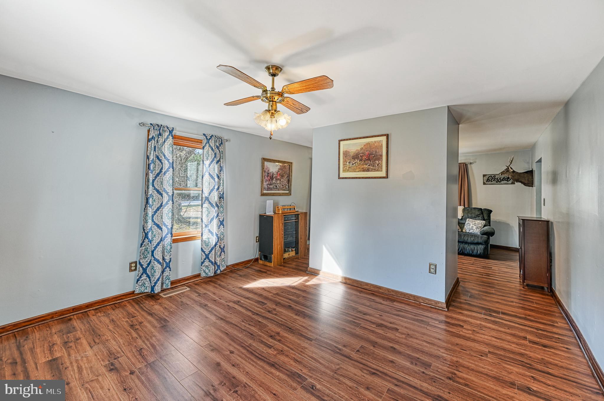 3492 Roundabout Road Louisa, VA 23093 - Photo 15 of 35 a view of a livingroom with wooden floor and a ceiling fan