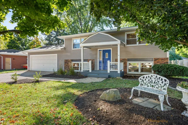 a front view of house with a garden and patio