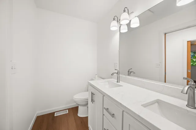 a bathroom with a sink a toilet and a mirror