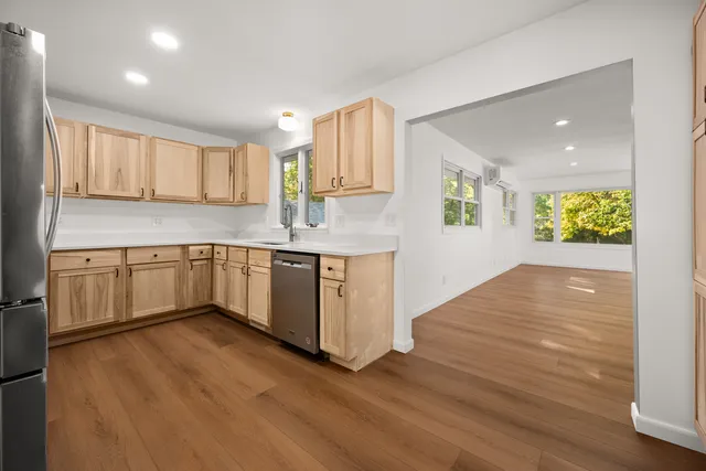 a kitchen with a sink cabinets and wooden floor