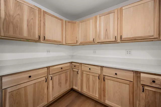 a kitchen with white cabinets and a sink