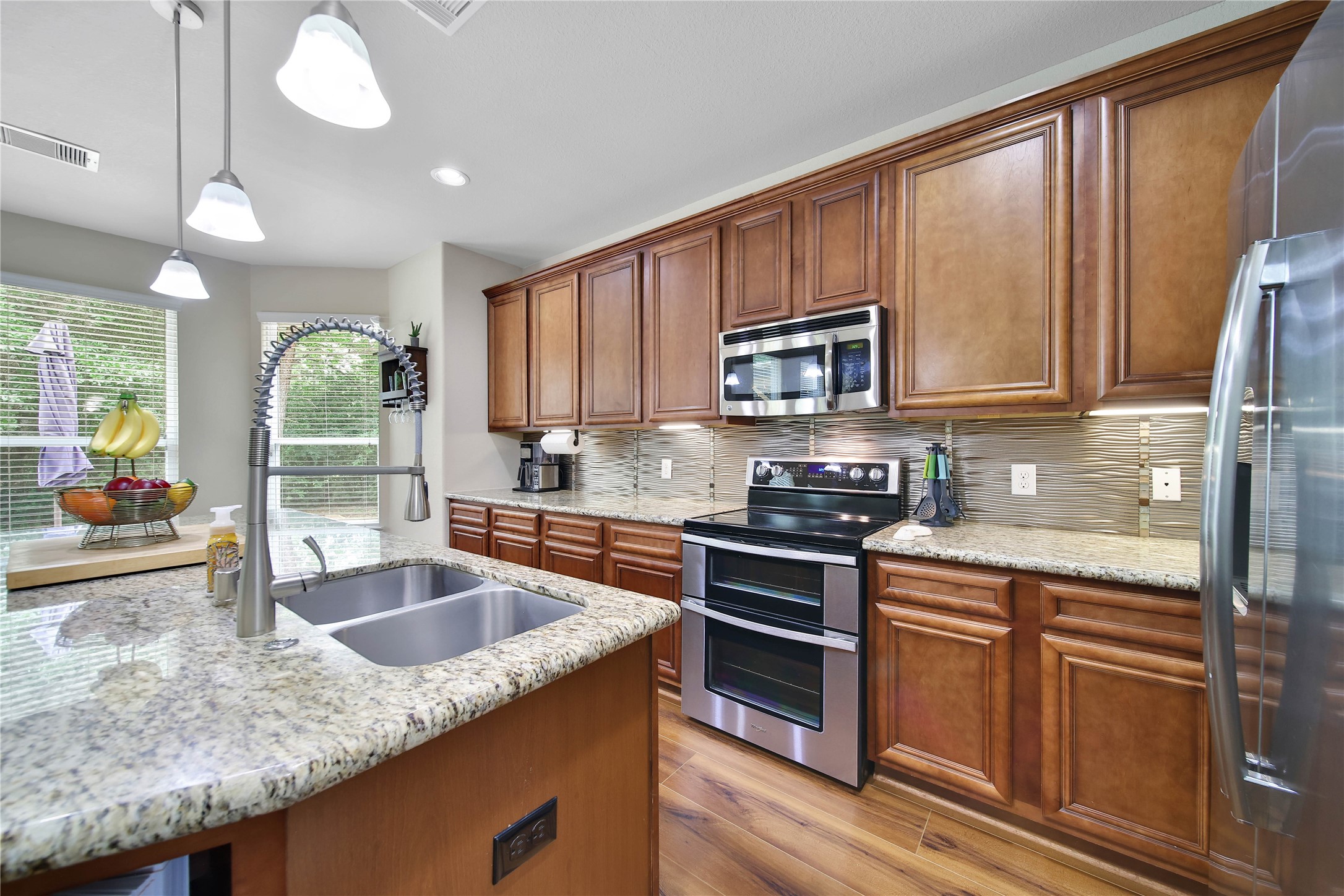 9223 Wapiti Trail Conroe, TX 77303 - Photo 21 of 45 a kitchen with granite countertop a sink a counter top space appliances and cabinets