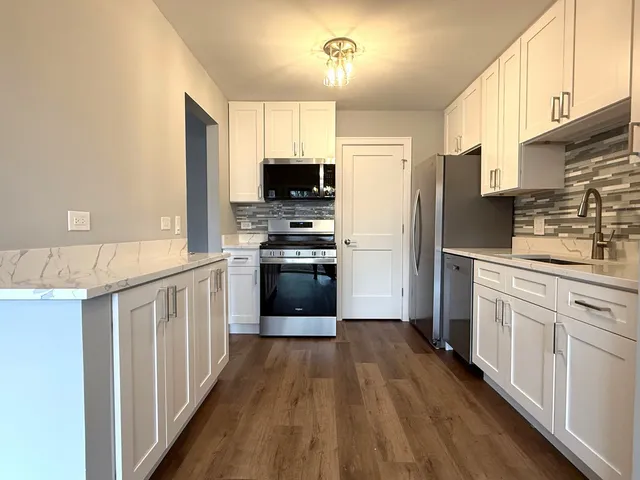 a kitchen with stainless steel appliances a refrigerator stove and sink