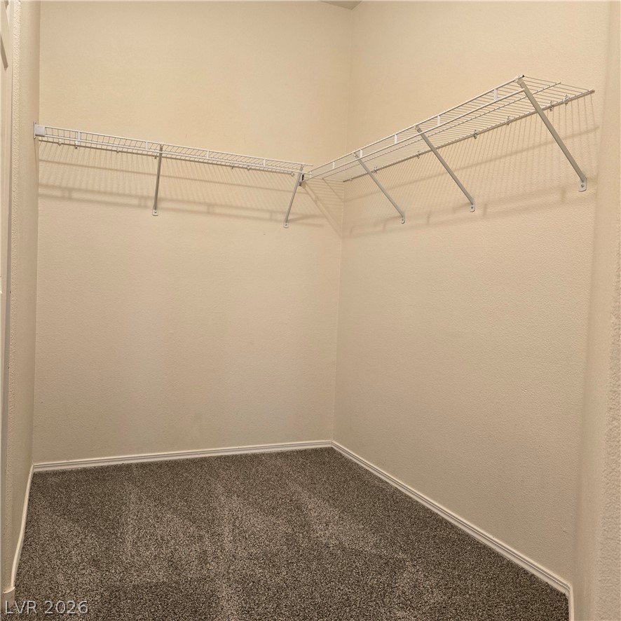 9234 Kingston Road Henderson, NV 89074 - Photo 29 of 38 Ample wire shelving and soft carpeting define this practical closet space.
