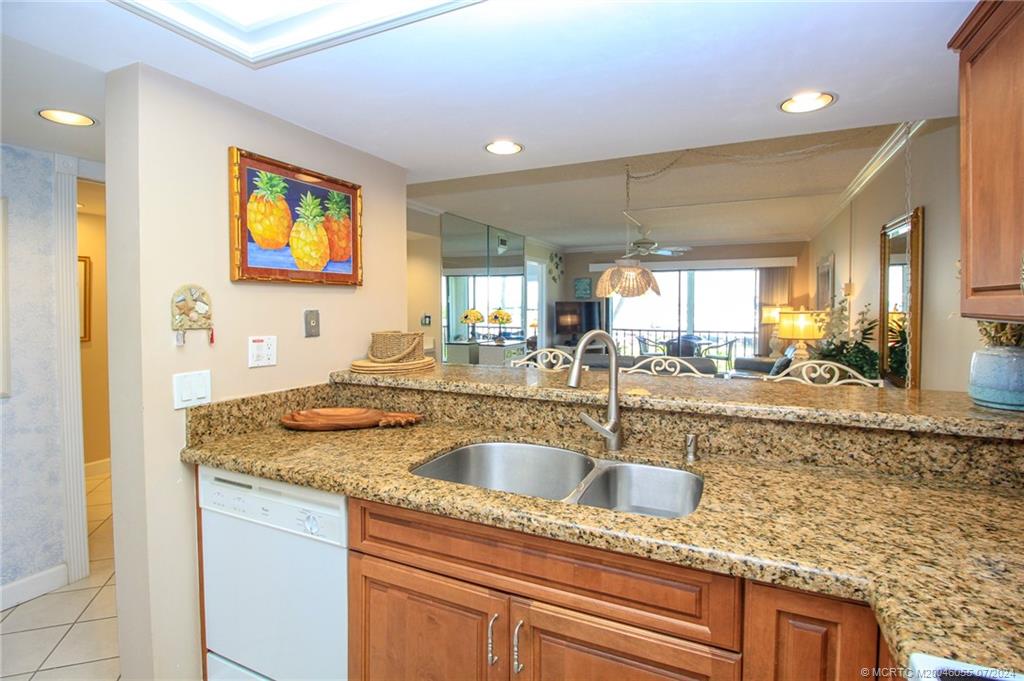 350 Northeast Edgewater Drive, Unit 202 Stuart, FL 34996 - Photo 12 of 28 a kitchen with a sink and a wooden floor