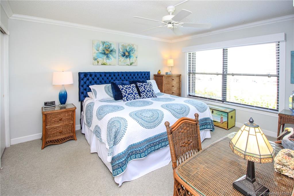 350 Northeast Edgewater Drive, Unit 202 Stuart, FL 34996 - Photo 15 of 28 a bedroom with bed and balcony