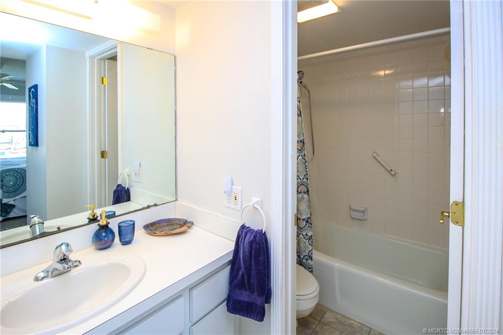 350 Northeast Edgewater Drive, Unit 202 Stuart, FL 34996 - Photo 18 of 28 a bathroom with a sink toilet and shower