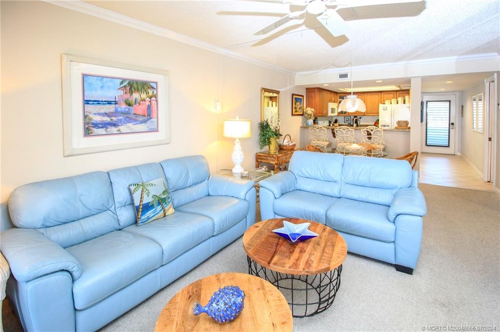 350 Northeast Edgewater Drive, Unit 202 Stuart, FL 34996 - Photo 5 of 28 a living room with furniture and a large window