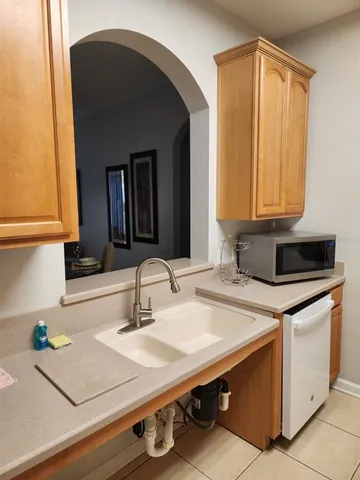 a kitchen with a sink cabinets and a window