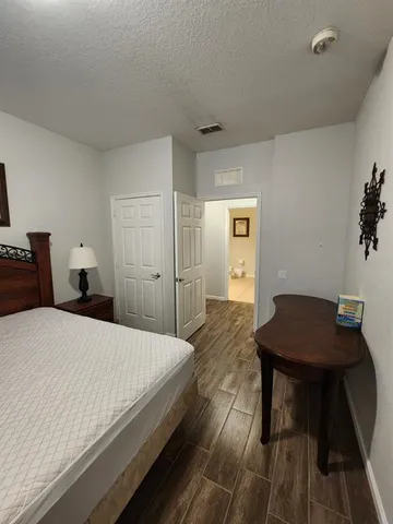 a bedroom with a bed and a table in it