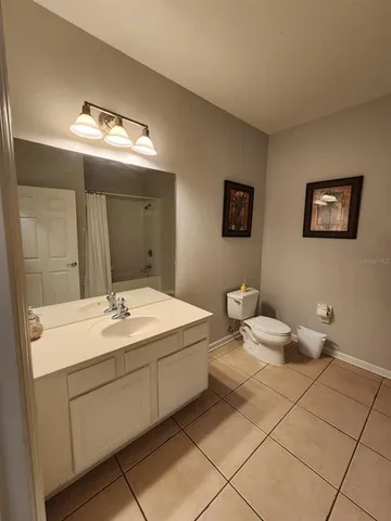 a spacious bathroom with a double vanity sink and a mirror