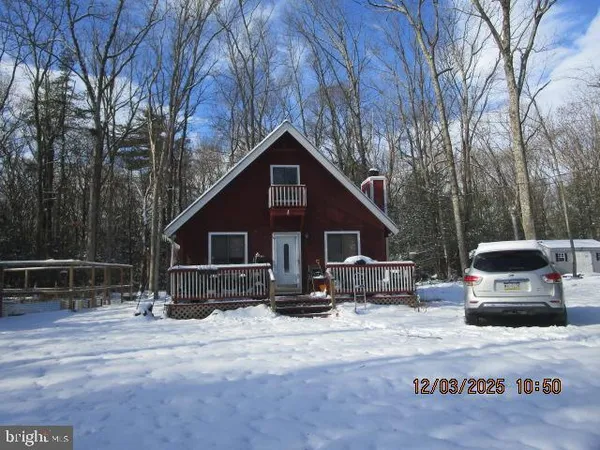 a front view of a house with cars parked