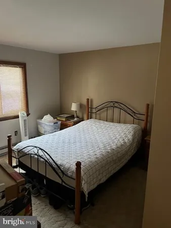 a bedroom with a bed table and window