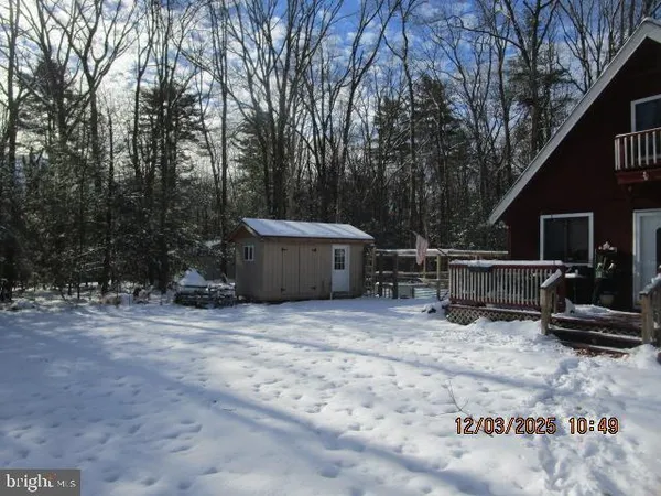 a backyard of a house with wooden fence and trees