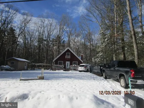 a view of a house with snow on the road