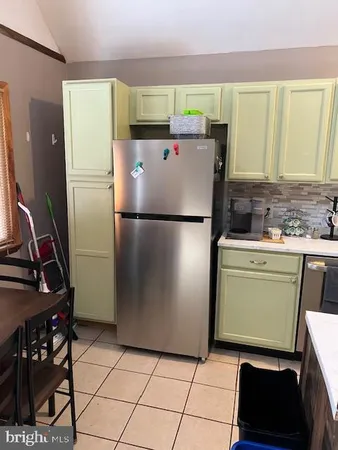 a white refrigerator freezer and a stove in a kitchen