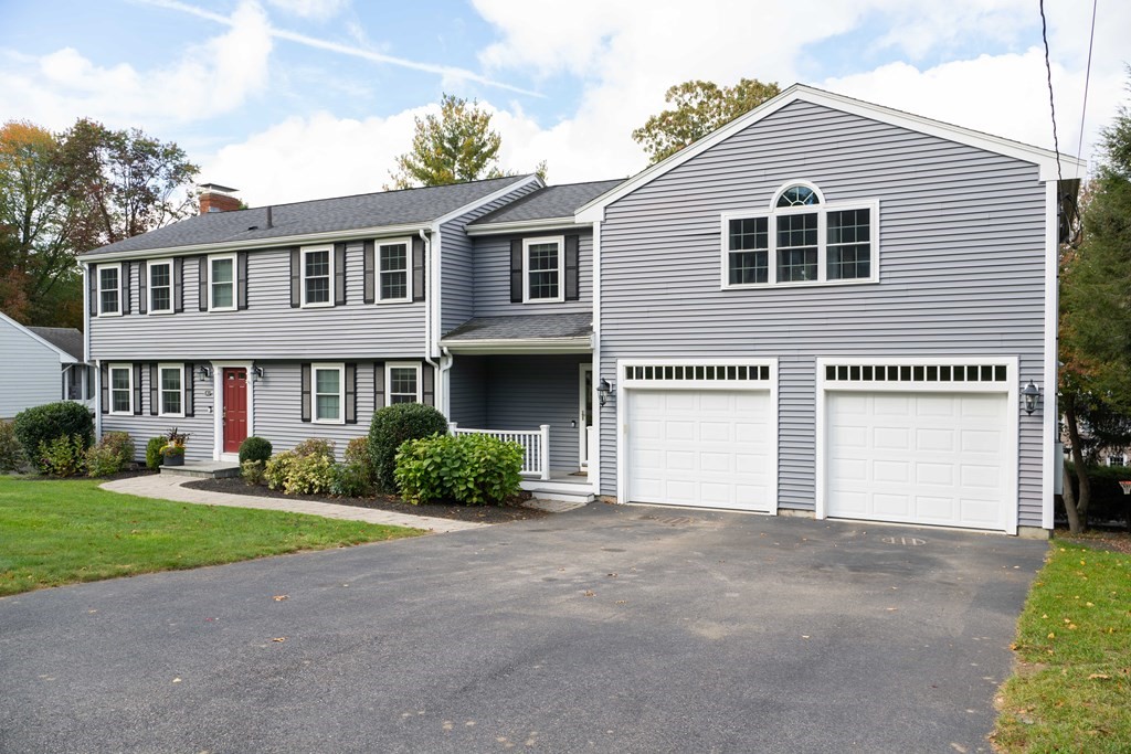 a view of a house with a yard and plants