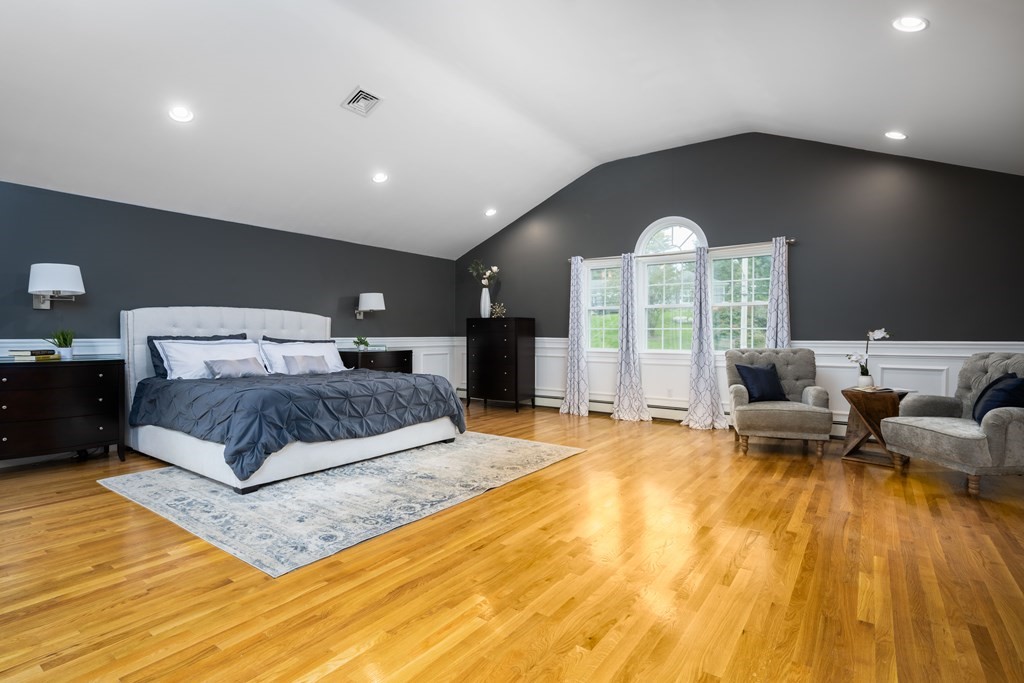 6 Old Meadow Lane Canton, MA 02021 - Photo 20 of 35 a spacious bedroom with a large bed and a chandelier