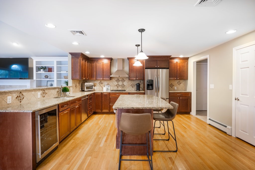 6 Old Meadow Lane Canton, MA 02021 - Photo 4 of 35 a kitchen with stainless steel appliances kitchen island granite countertop a sink and cabinets