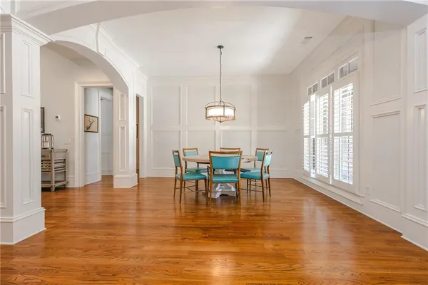 a view of a dining room with furniture and wooden floor