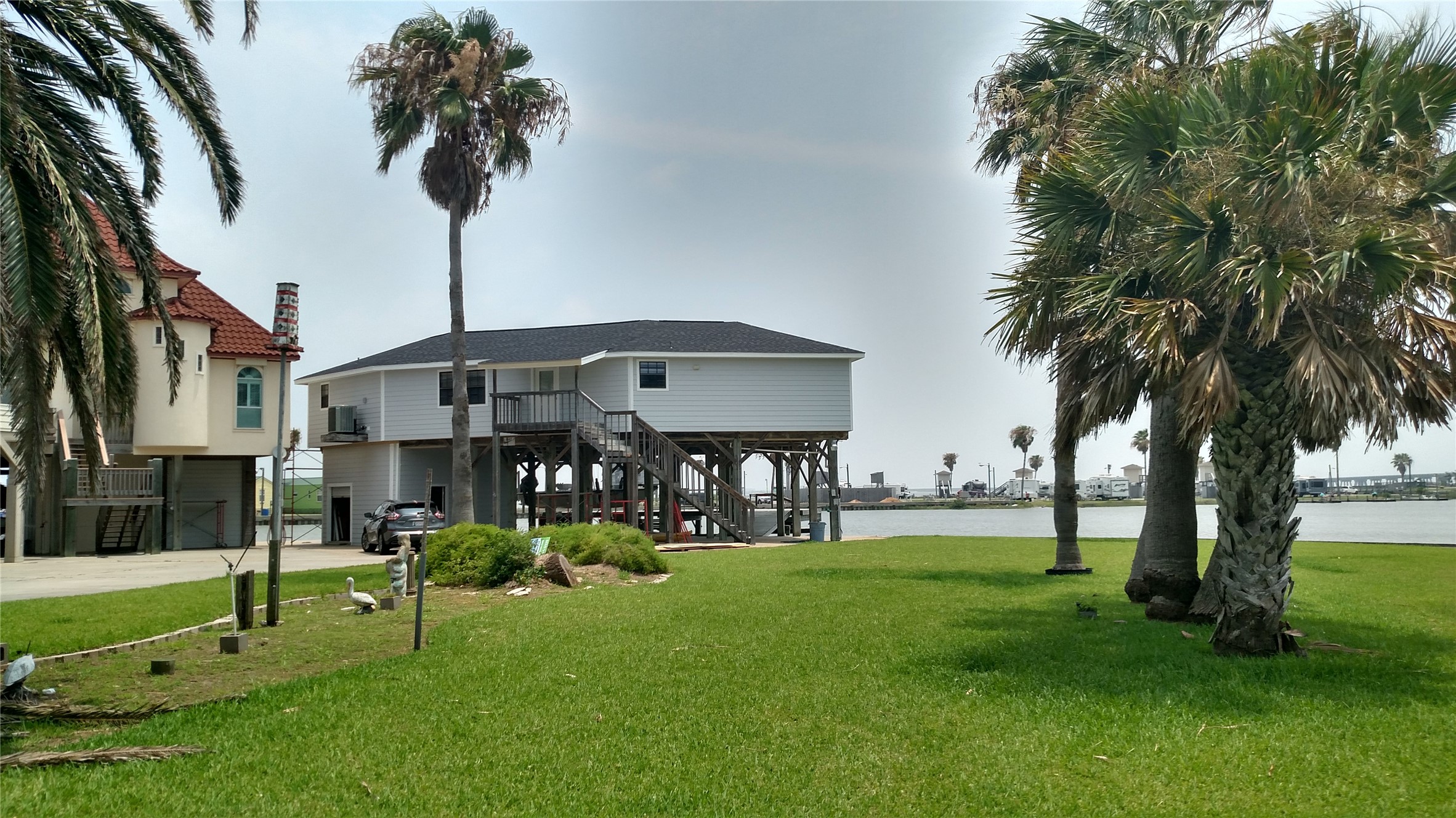 0 Anchor Drive Freeport, TX 77541 - Photo 5 of 9 a front view of a house with garden and a tree