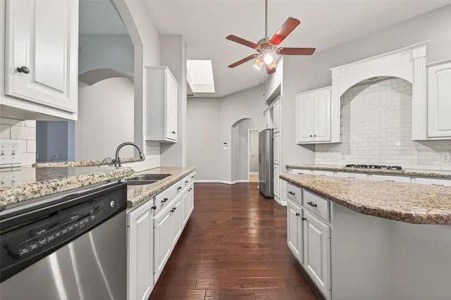 a kitchen with stainless steel appliances granite countertop a stove and a sink
