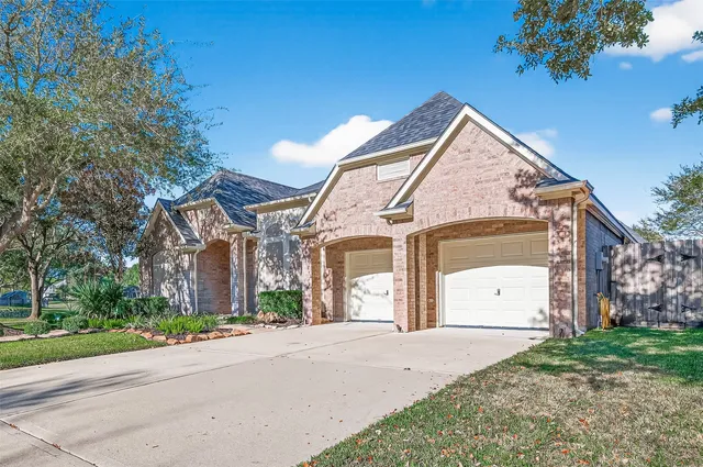a front view of a house with a yard and a garage