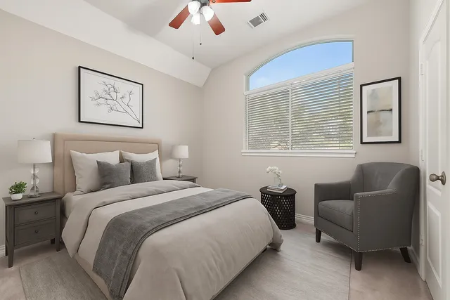 a bedroom with bed couch and window