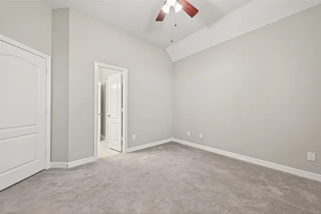 an empty room with a empty space and a ceiling fan