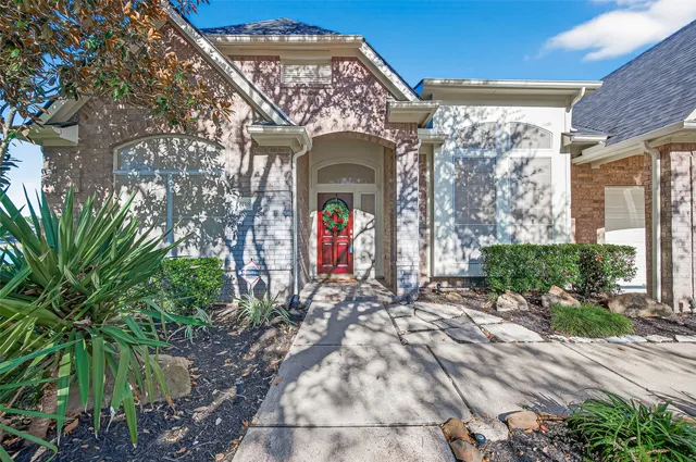 a front view of a house with lots of green space