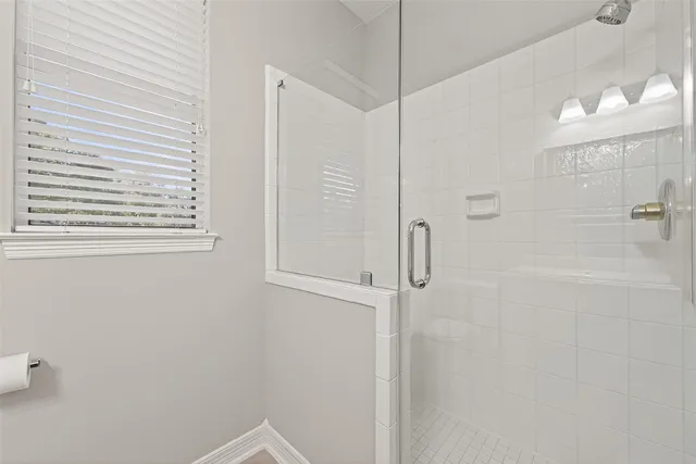 a bedroom with a large bed and windows