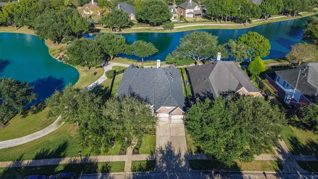 an aerial view of a house with a garden and swimming pool