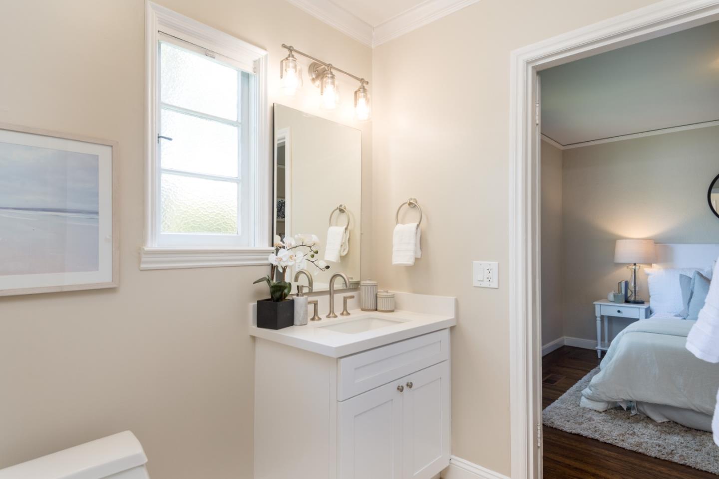 1000 Harvard Road San Mateo, CA 94402 - Photo 17 of 32 a en suite bathroom with a double vanity sink and a mirror