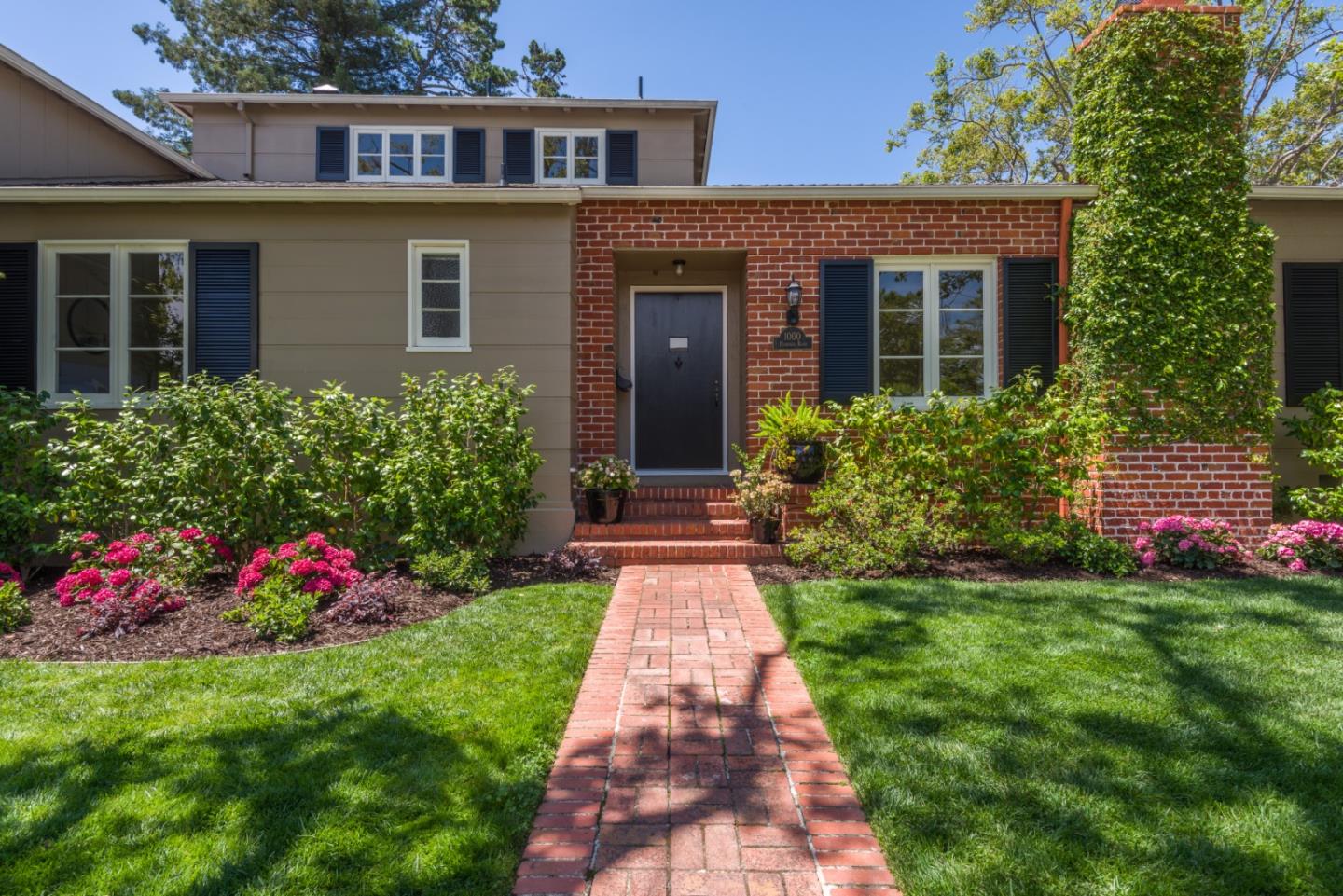 1000 Harvard Road San Mateo, CA 94402 - Photo 2 of 32 a front view of a house with a yard and potted plants
