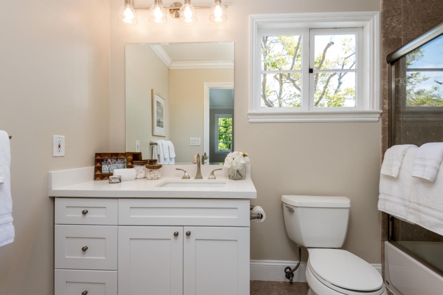 1000 Harvard Road San Mateo, CA 94402 - Photo 21 of 32 a bathroom with a toilet a sink a mirror a window and vanity
