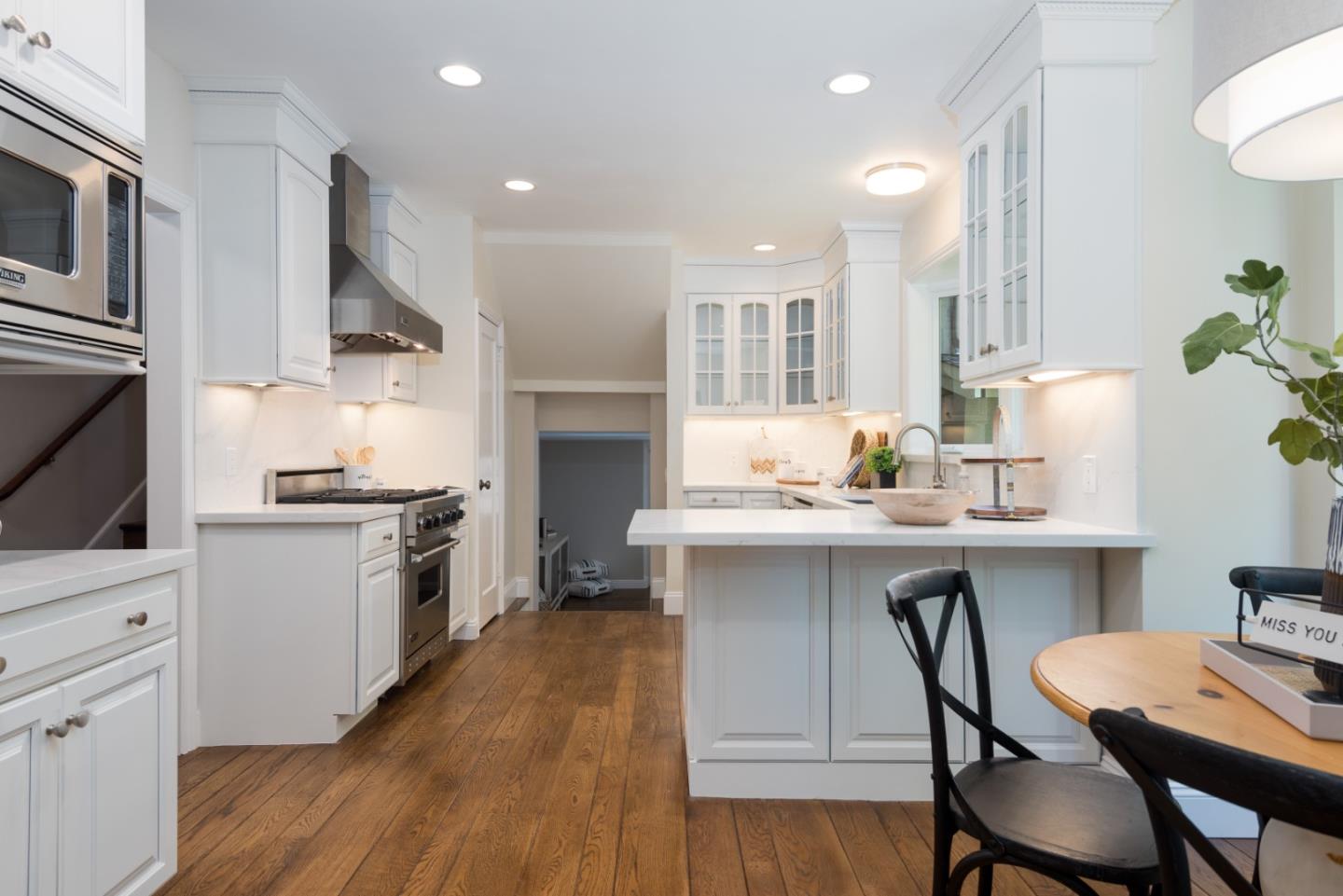 1000 Harvard Road San Mateo, CA 94402 - Photo 7 of 32 a kitchen with a table chairs stove and microwave
