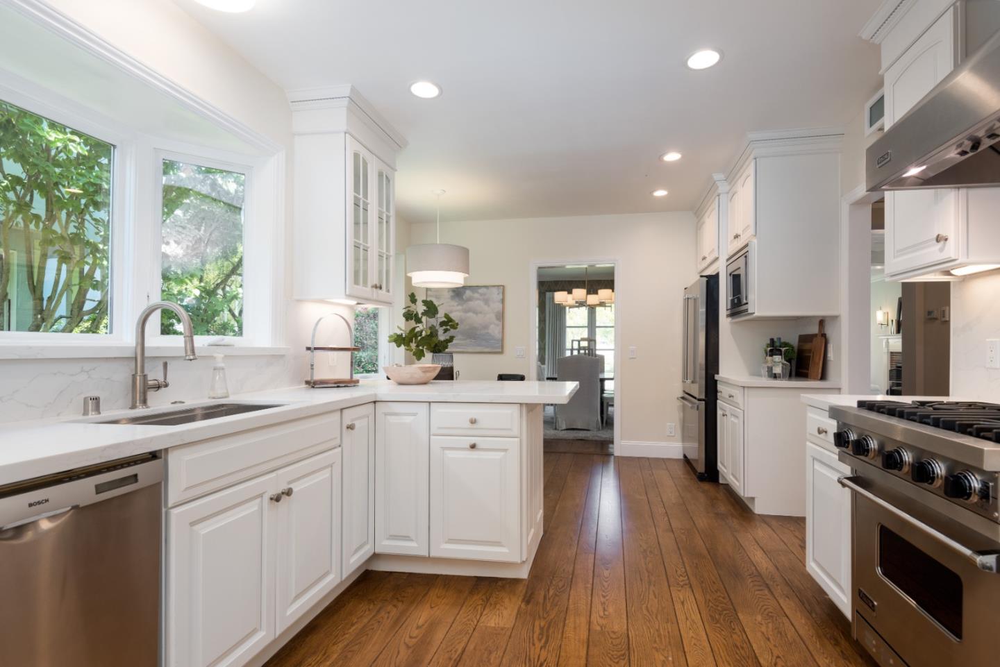1000 Harvard Road San Mateo, CA 94402 - Photo 9 of 32 a kitchen with a sink stove and wooden cabinets