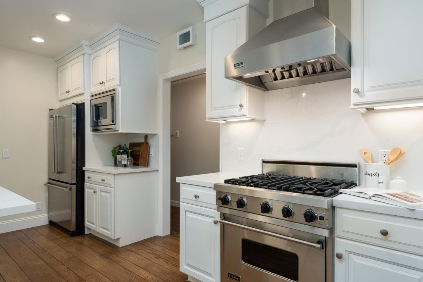 1000 Harvard Road San Mateo, CA 94402 - Photo 10 of 32 a kitchen with granite countertop stainless steel appliances and wooden cabinets