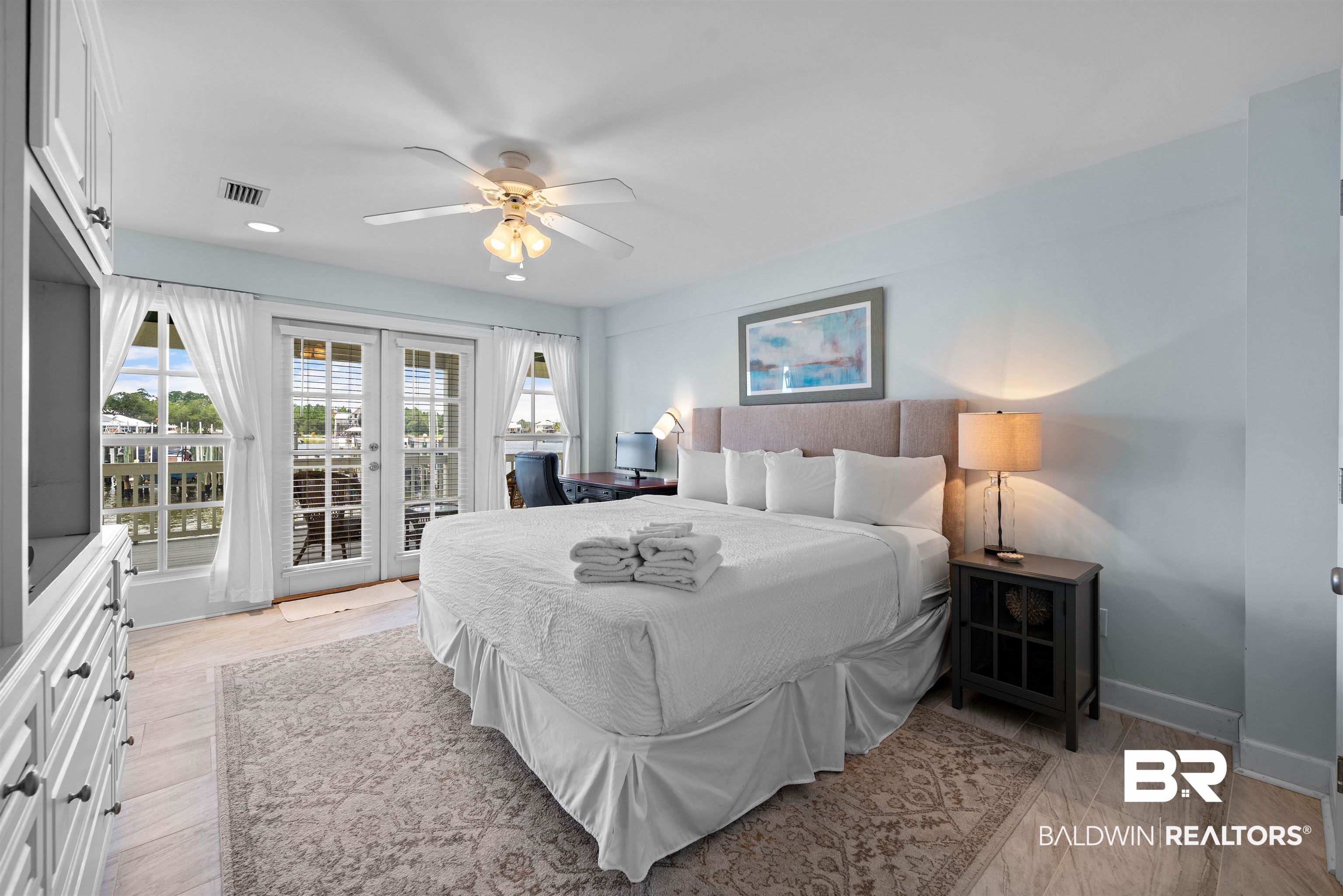 3434 Mariner Circle Orange Beach, AL 36561 - Photo 23 of 38 Bedroom featuring ceiling fan and access to exterior. Outstanding views of Cotton Bayou and the marina to greet you every morning.