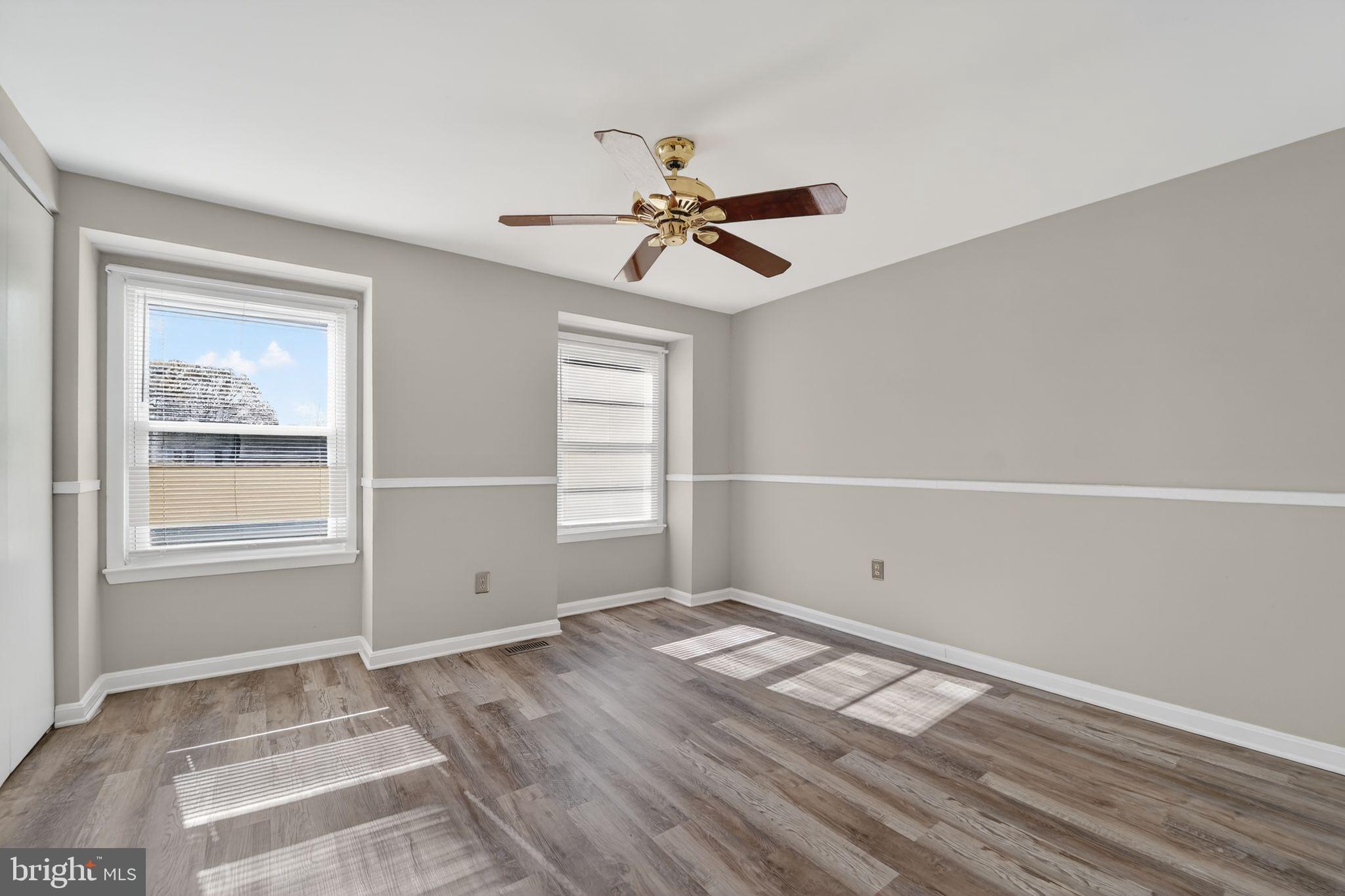 14 Pickens Court Baltimore, MD 21236 - Photo 13 of 30 a view of empty room with wooden floor and fan