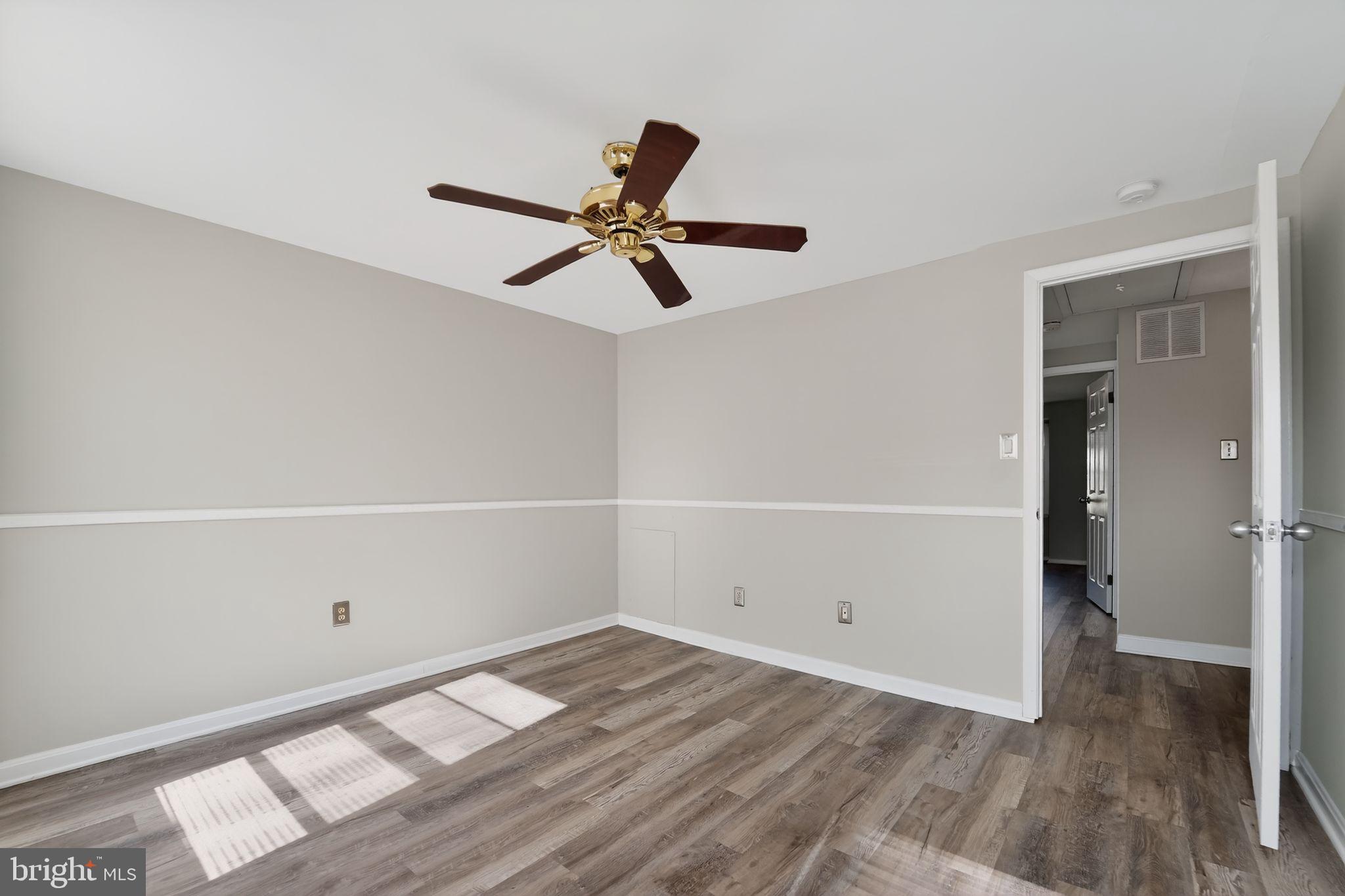 14 Pickens Court Baltimore, MD 21236 - Photo 14 of 30 a view of a room with wooden floor and a ceiling fan