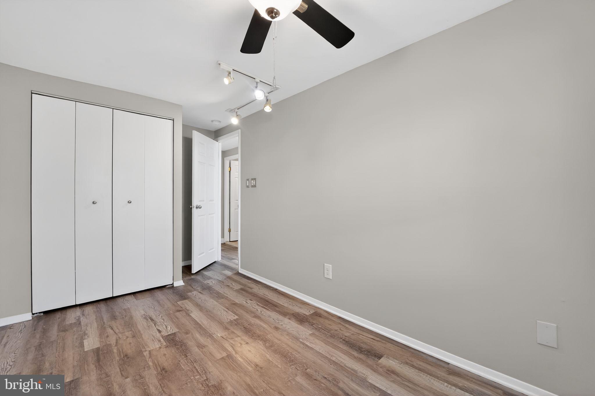 14 Pickens Court Baltimore, MD 21236 - Photo 17 of 30 an empty room with ceiling fan and window